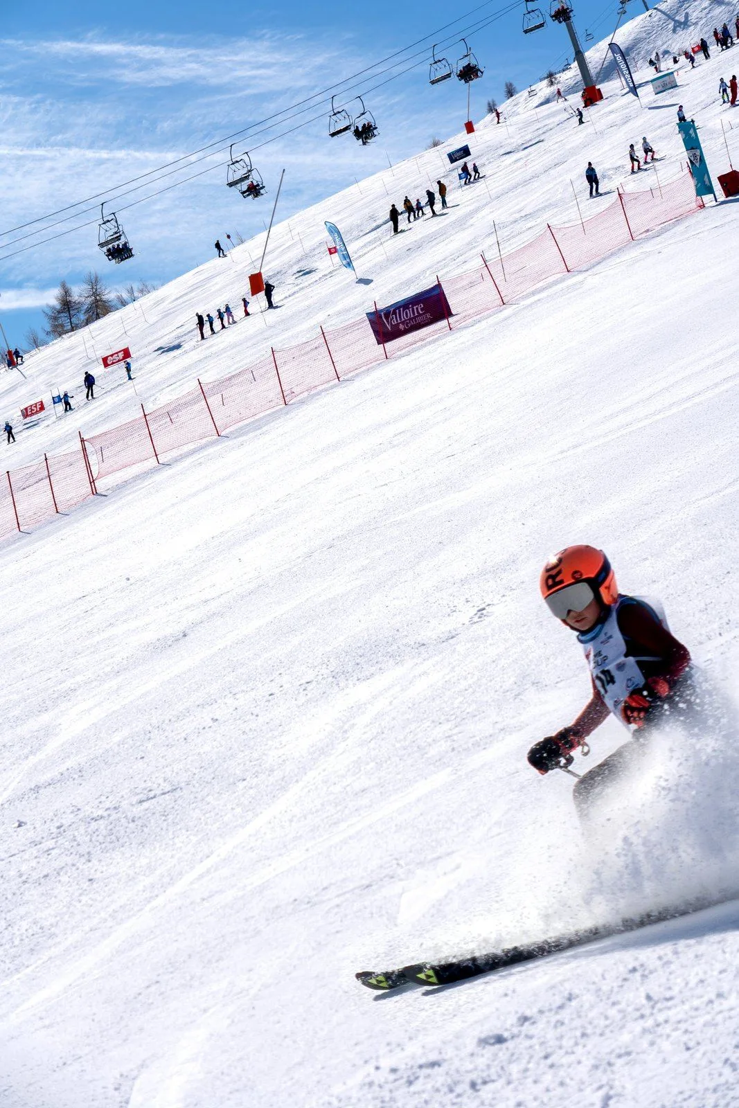 Skier carving below the chairlifts, JB Cup in Valloire
